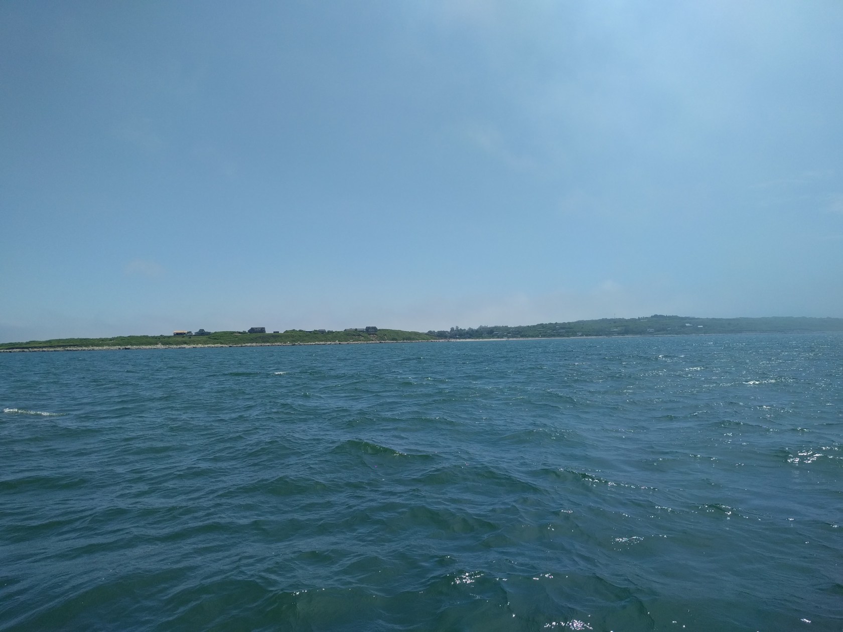 Cuttyhunk Island, just after breaking through the fog, who’s remnants can be seen on the right edge of the frame.